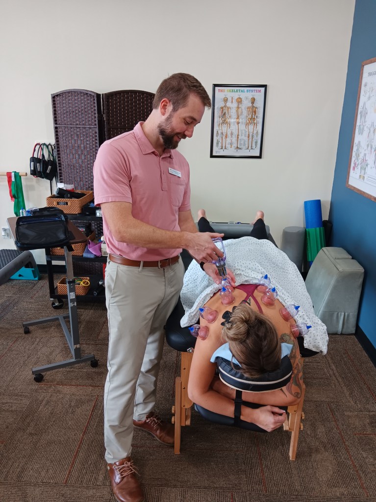 Jason Salisbury PT, providing pain relief for neck, back and shoulders with cupping.